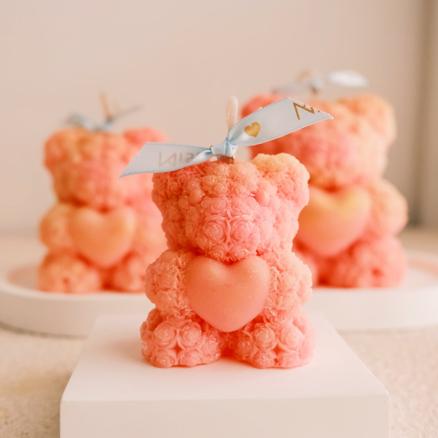Miss Blooms Blossom Bear Candle set of three sizes on display platform