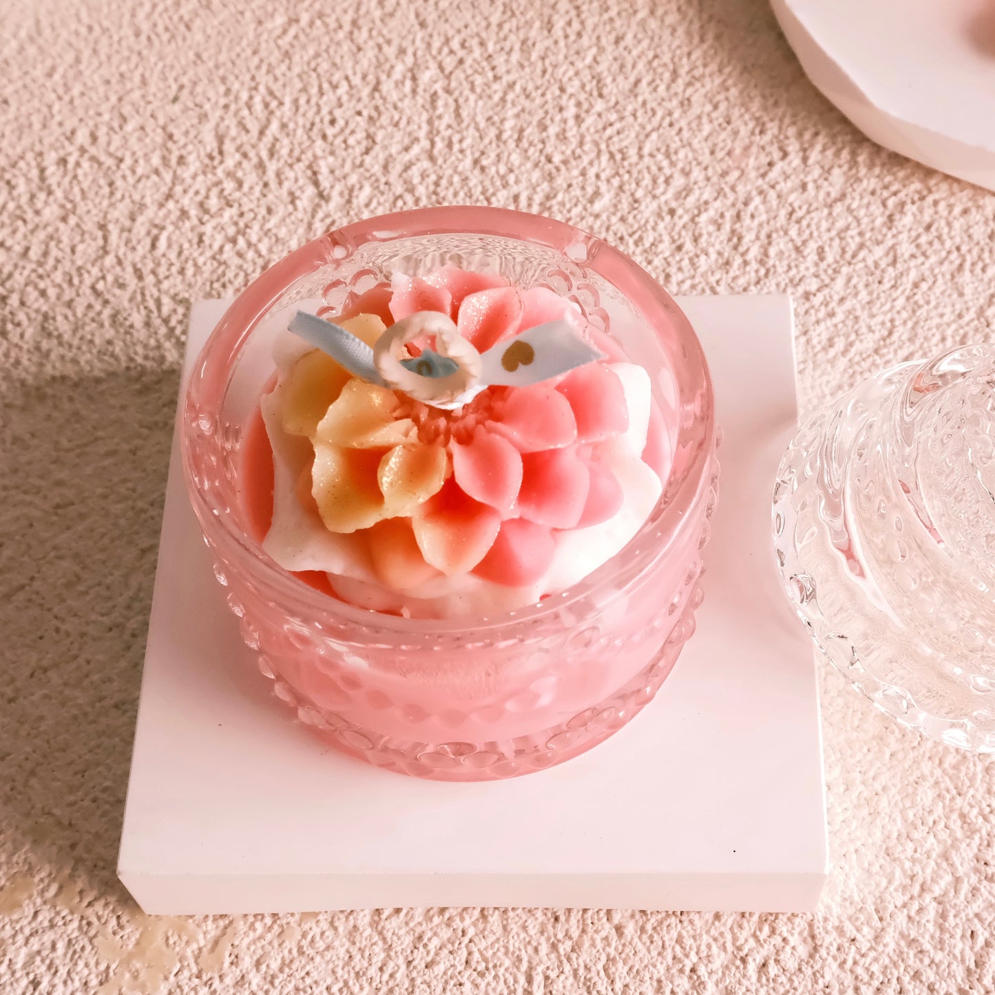 Miss Blooms Blossom Sparkle Jar Candle — top-down view of pink dahlia wax flower arrangement inside crystal jar