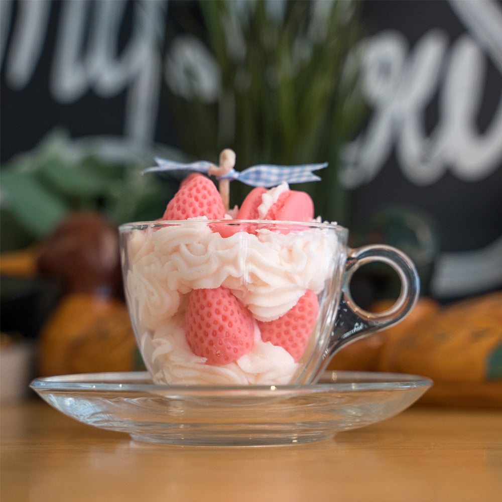 Miss Blooms Strawberry Tea Cup Candle displayed with other dessert candles in home setting