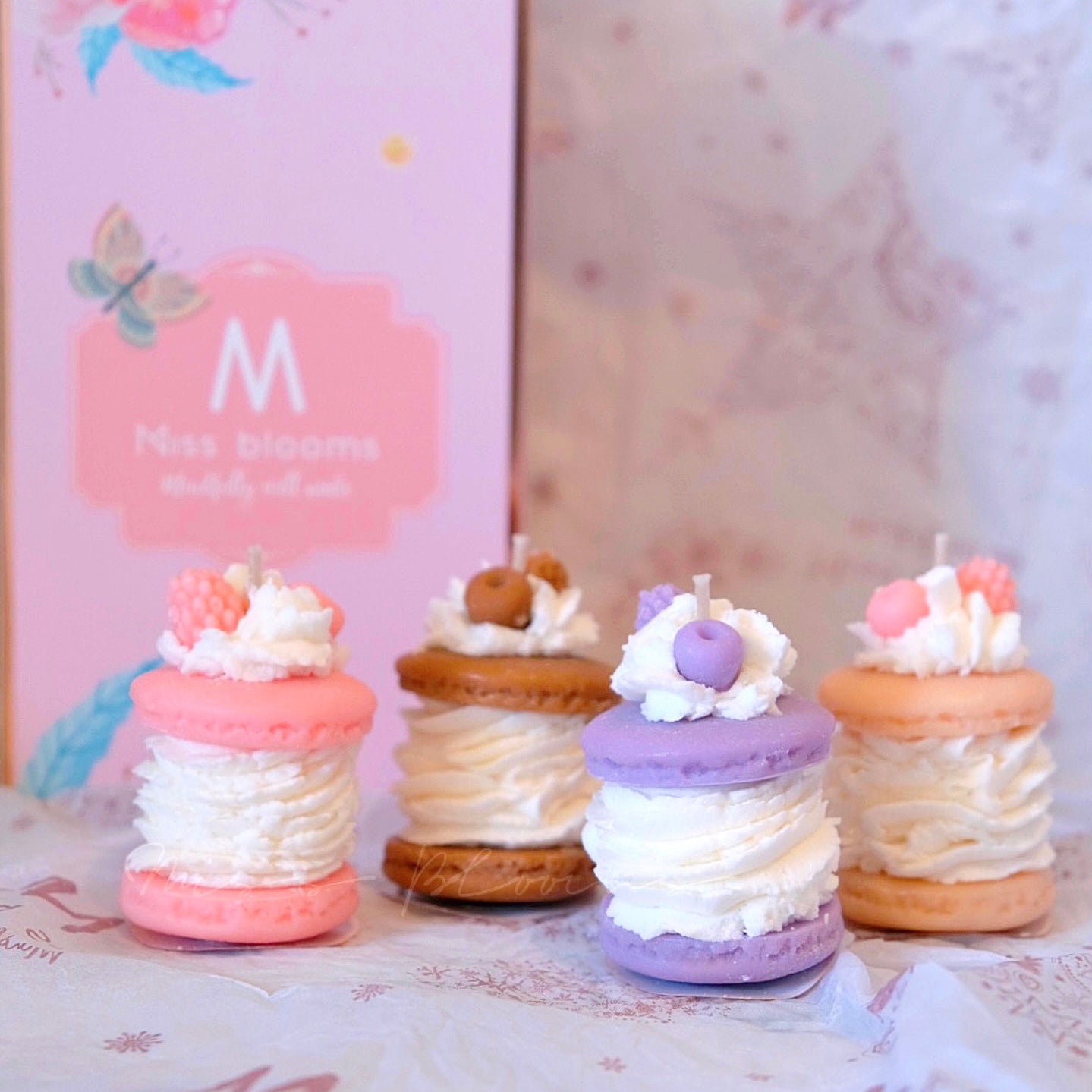Close-up of Miss Blooms Macaron Candle showing pastel layered macaron shape with handmade wax decorations