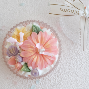 Miss Blooms Flower Bowl Candle in a crystal flat bowl with gerbera daisy, pink roses, lavender flowers and mixed blooms, lid removed