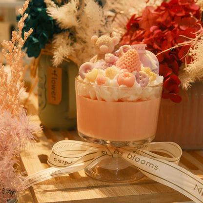 Miss Blooms Giant Sundae Candle styled with red florals showing tall glass profile