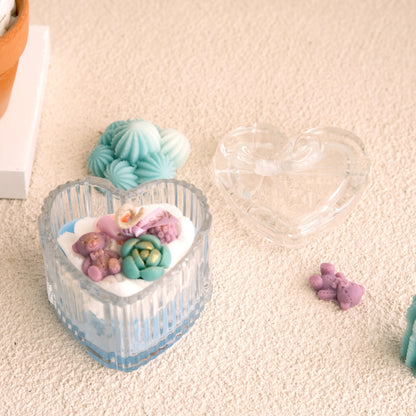 Cozy Heartscape Cactus Candle heart jar lid off — wax succulent and teddy bear arrangement in blue crystal jar by Miss Blooms, handmade in Canberra