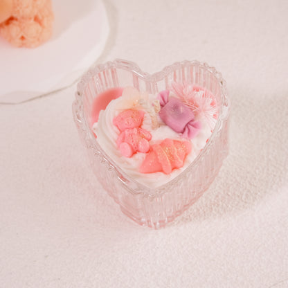 Miss Blooms Eternal Love Heart Jar Candle in blush pink heart-shaped glass jar, topped with teddy bear, flowers and candy wax decorations