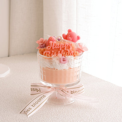 Miss Blooms Sweet Treats Giant Sundae Happy Birthday Candle in pedestal glass — Happy Birthday wax sign, teddy bear and floral decorations in peach and coral tones