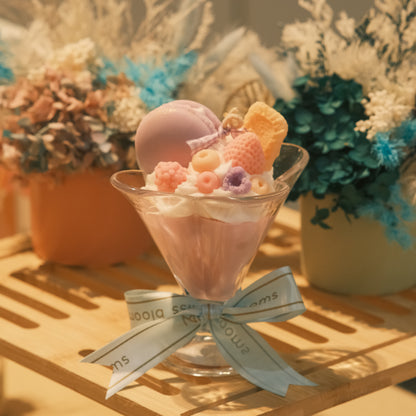 Miss Blooms Sweet Treats Cup Candle in martini glass with teddy bear and dessert wax toppings, tied with Miss Blooms satin ribbon, dried flowers in background