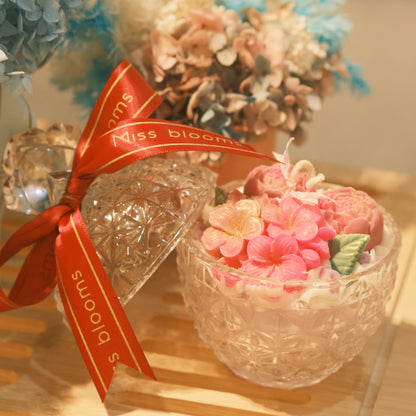 Miss Blooms Blossom Pineapple Jar Candle with diamond-cut crystal lid on, tied with Miss Blooms red and gold satin ribbon