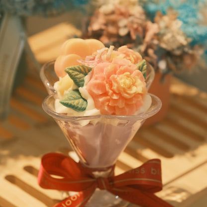 Miss Blooms Japanese Honeysuckle Flower Cup Candle — close-up of sculptural peach peony wax arrangement in martini glass