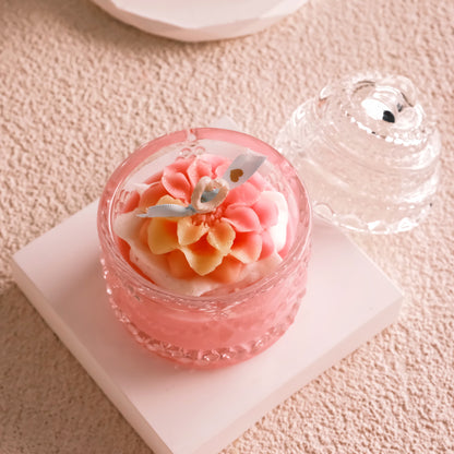 Miss Blooms Blossom Sparkle Jar Candle — round crystal glass jar open showing a large pink dahlia wax flower with blue leaf accents