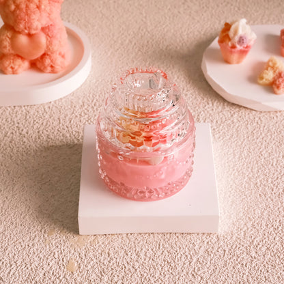Miss Blooms Blossom Sparkle Jar Candle in pink crystal jar with tiered dome lid, other Miss Blooms candles visible in the background