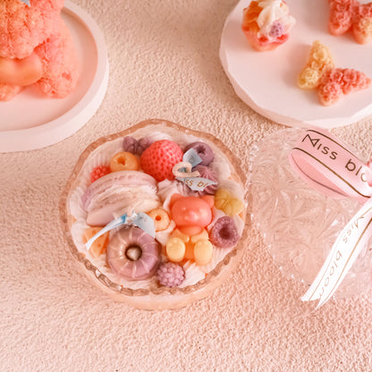 Miss Blooms Sweet Treats Open Bowl Candle — wide flat crystal plate covered in colourful wax strawberry, donut, berry and fruit decorations with Miss Blooms label