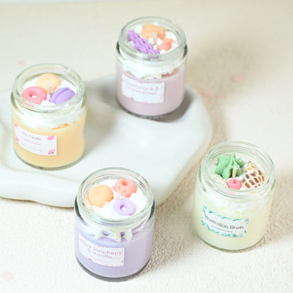Miss Blooms Small Jar Candles grouped overhead showing playful wax donut, macaron and floral decorations in pastel colours